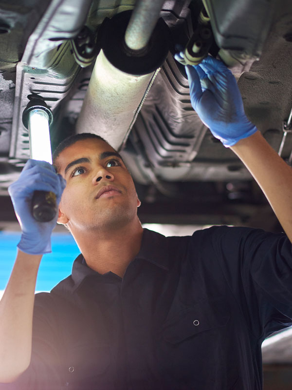 mechanic checking exhaust