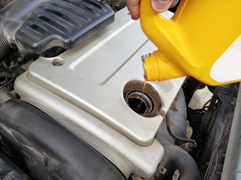 Man changing car oil regularly for maximum benefits in Millersville, MD